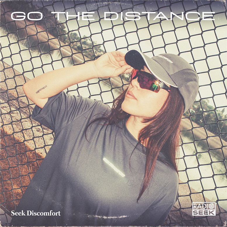 Person wearing a cap and sunglasses with 'Go The Distance' text on a textured background